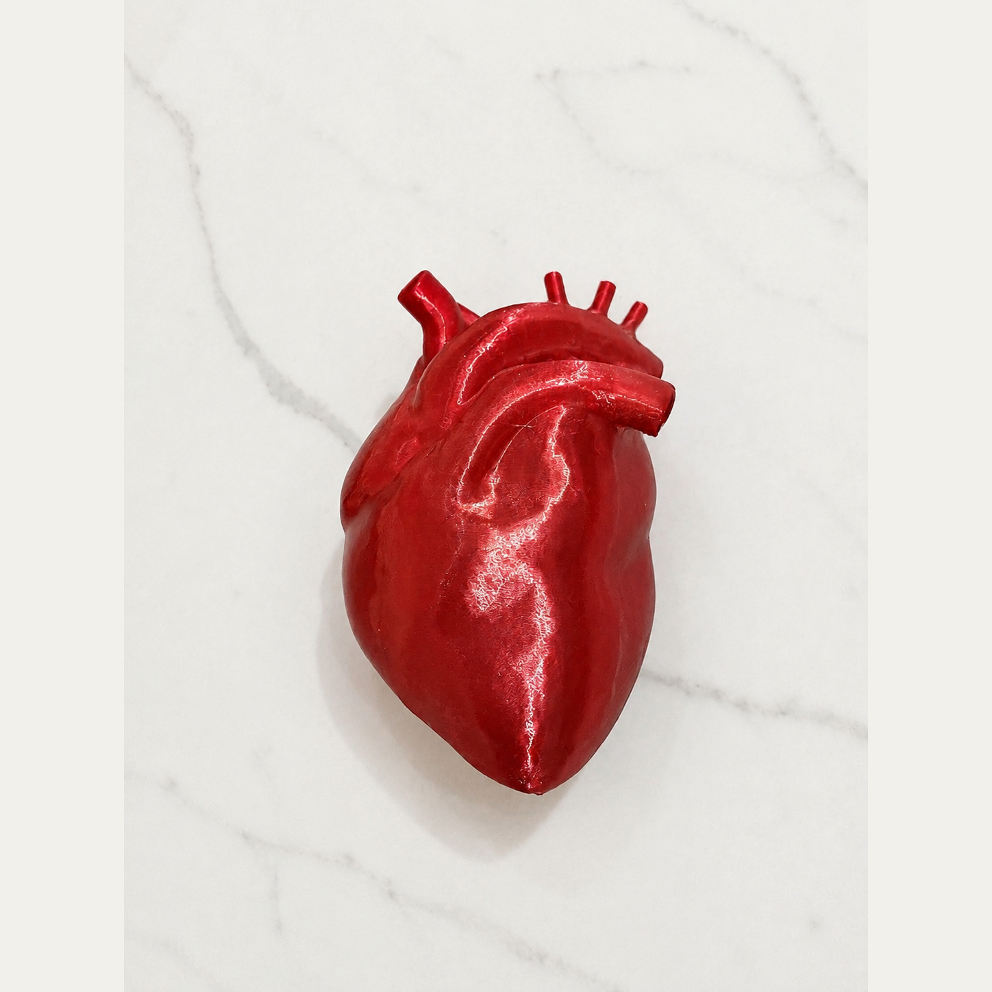 Finished translucent-red Heart Lite shown from the front